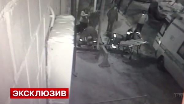 тело погибшего грузят на носилки